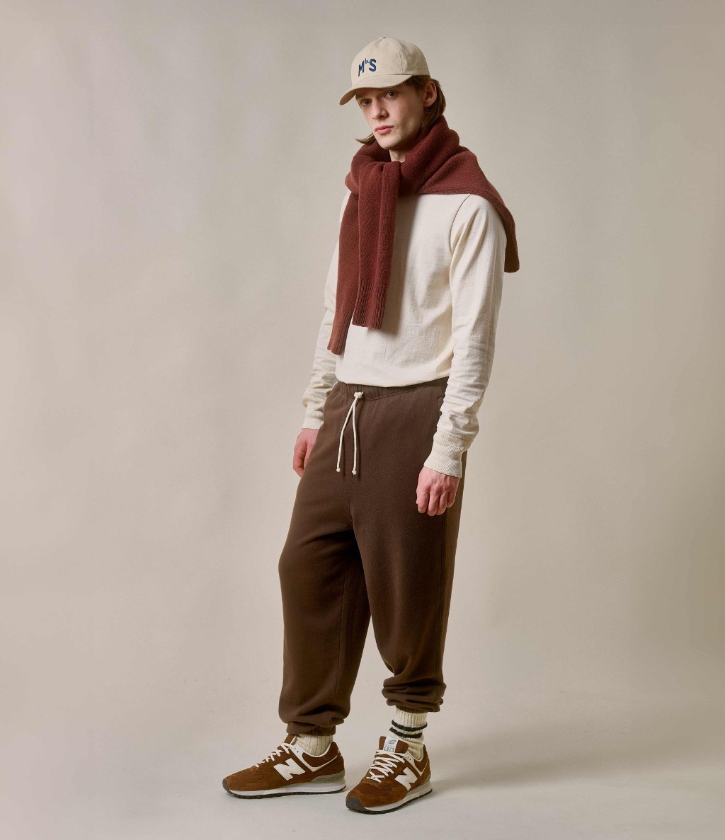 Man wearing ecru longsleeve henley and brown sweatpants