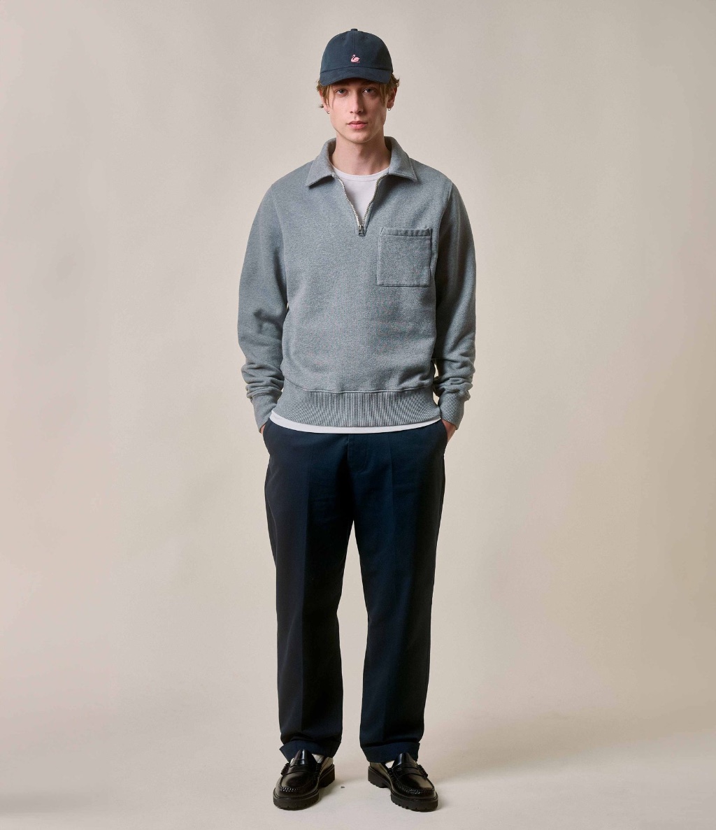 Man wearing grey half-zip sweatshirt and navy twill chinos