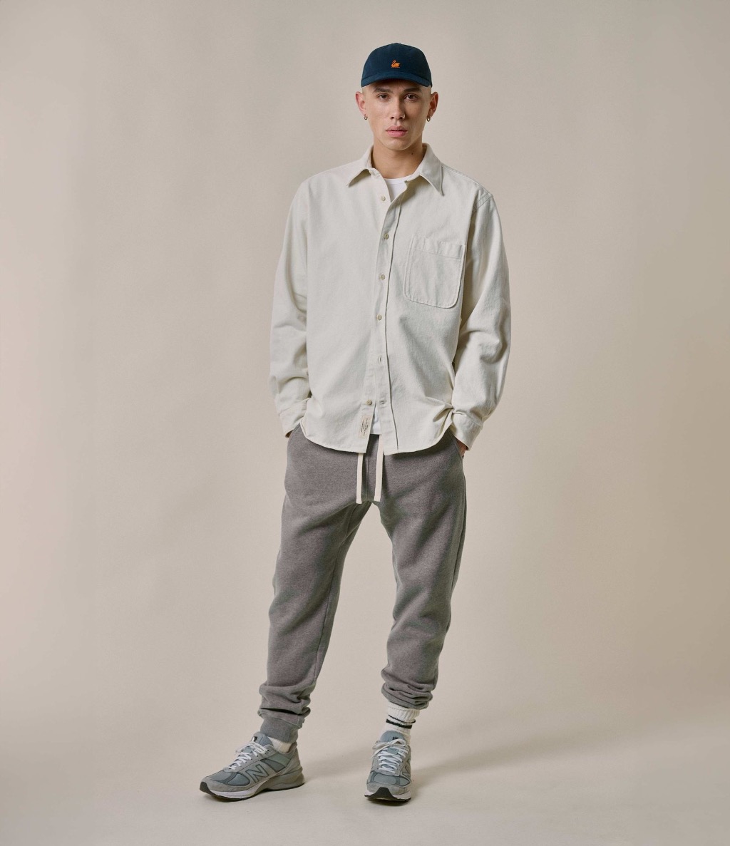 Man wearing ecru overshirt and grey sweatpants