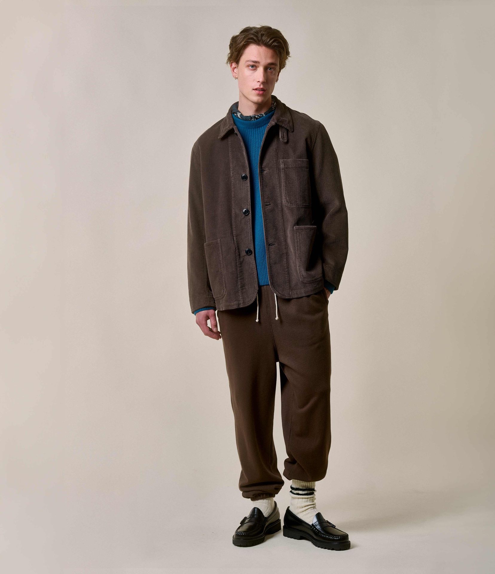 Man wearing brown corduroy jacket and sweatpants