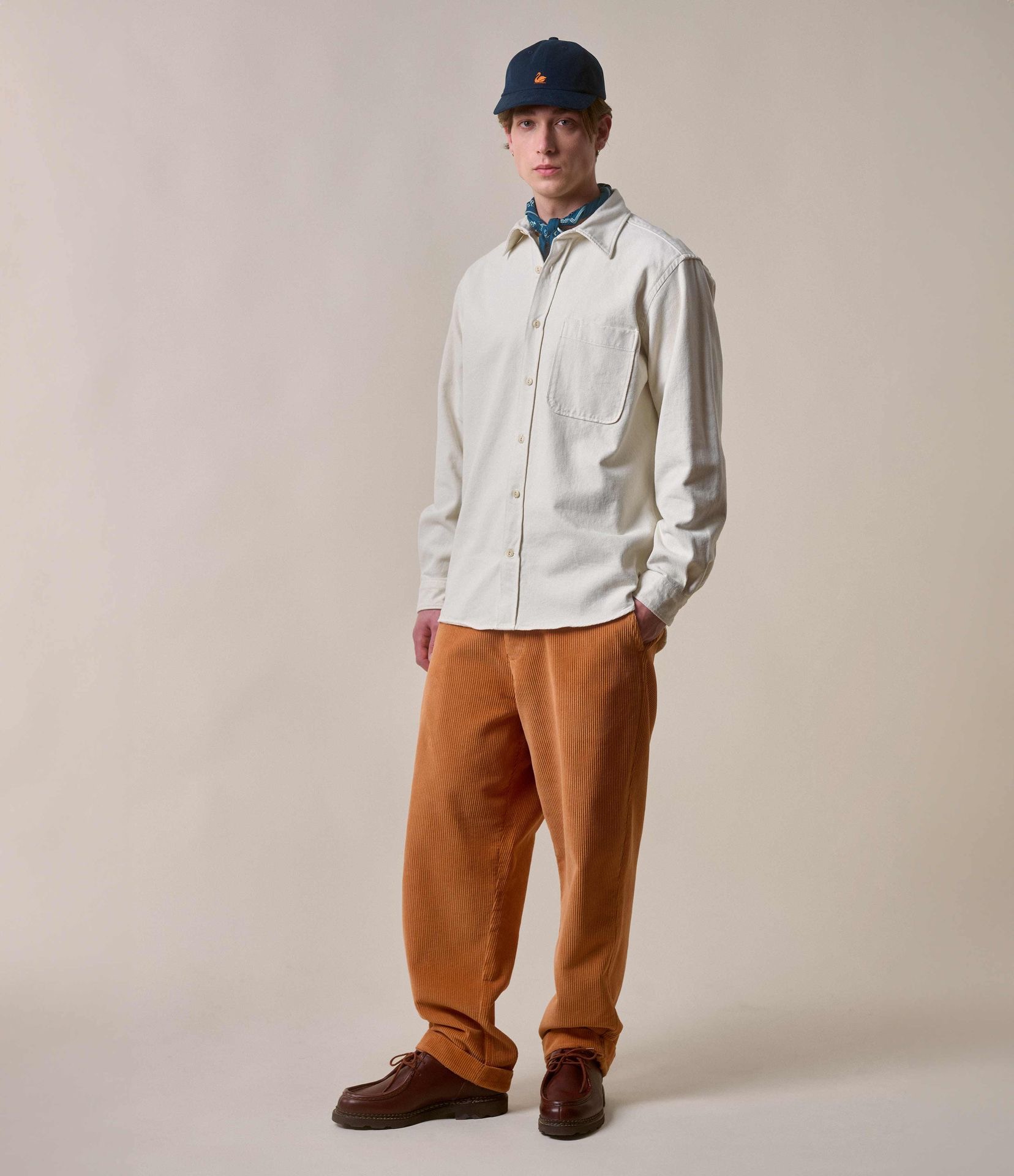 Man wearing ecru overshirt and orange corduroy chinos