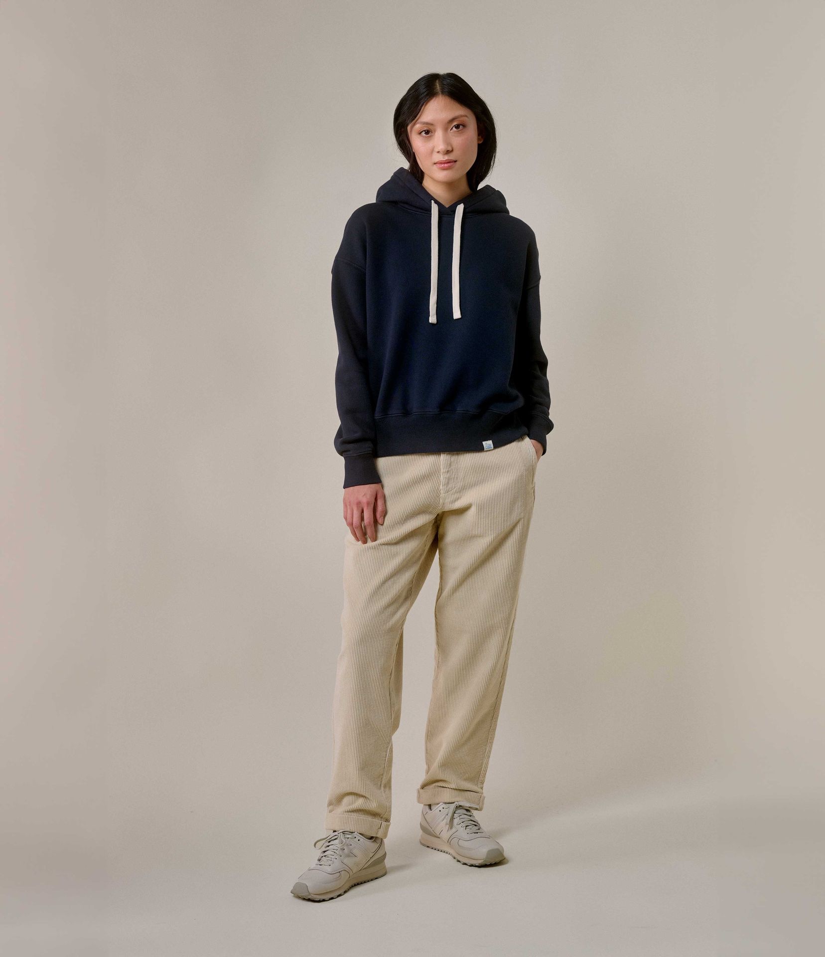 Woman wearing blue hoodie and ecru corduroy chinos